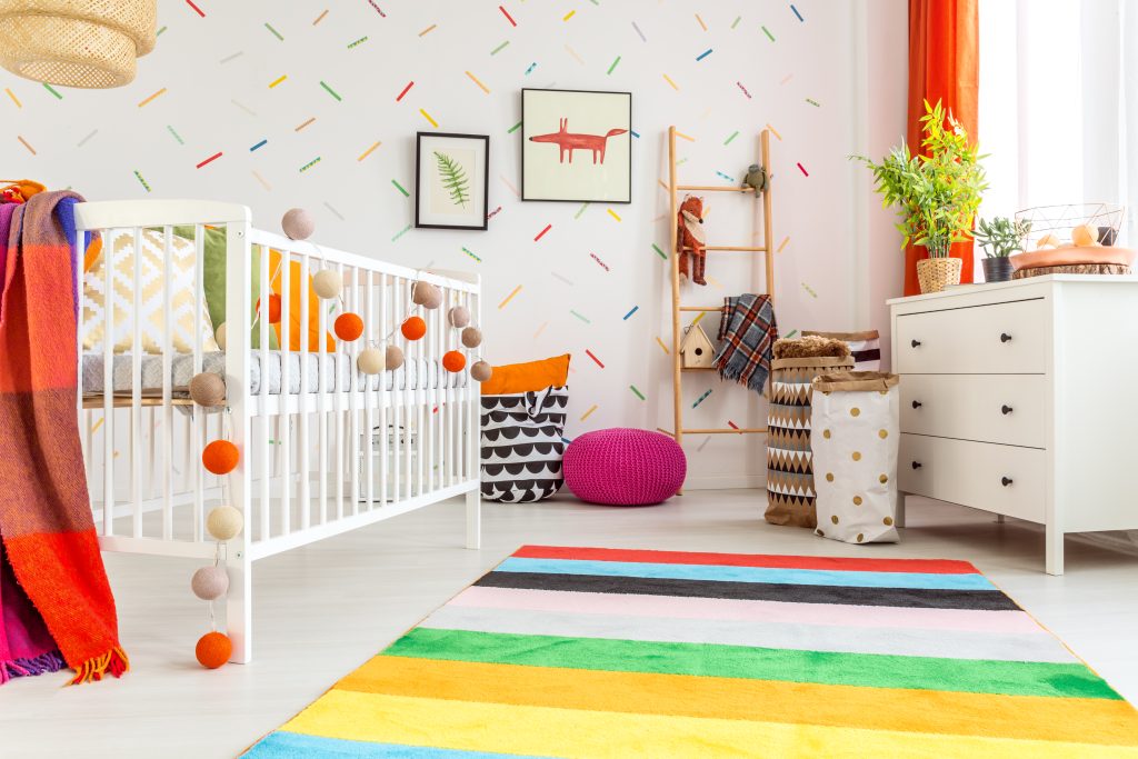 colorful nursery with peel and stick wallpaper and drapes