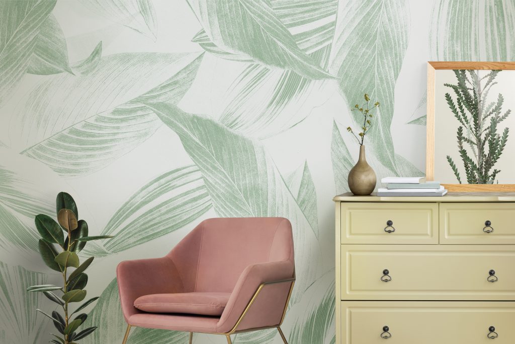 designer peel and stick wallpaper in a rental with a chair and plants