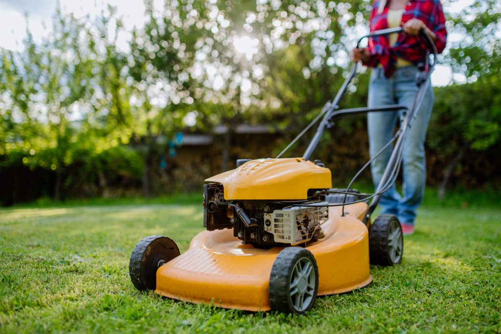 a renter mowing the lawn of their home