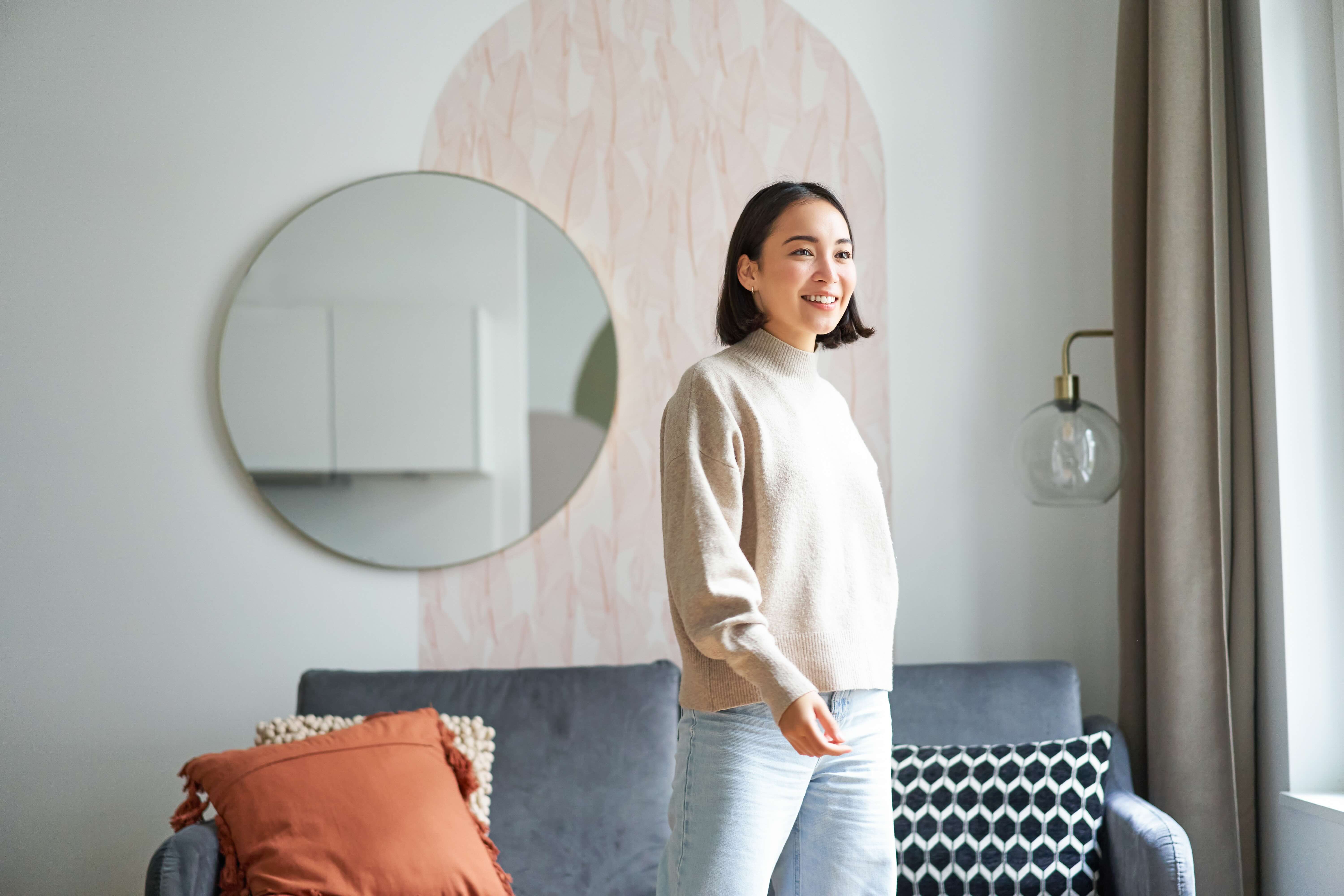 a renter walking in an apartment with renter friendly decor in the background